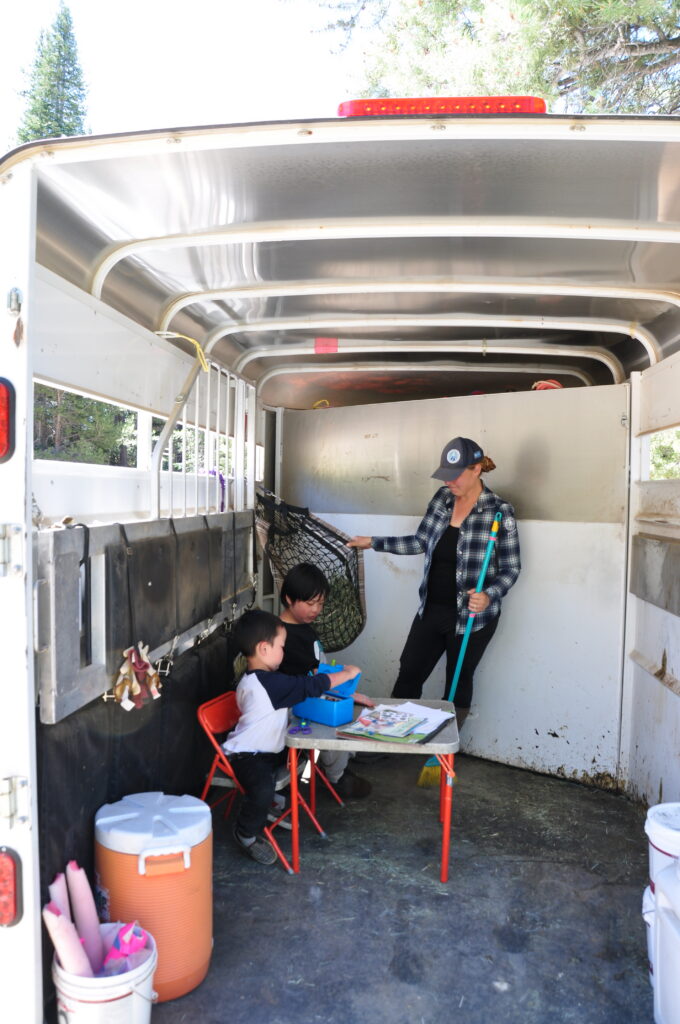 Irina Fedulow Plante leading an Achieve Tahoe equine program with two young participants.