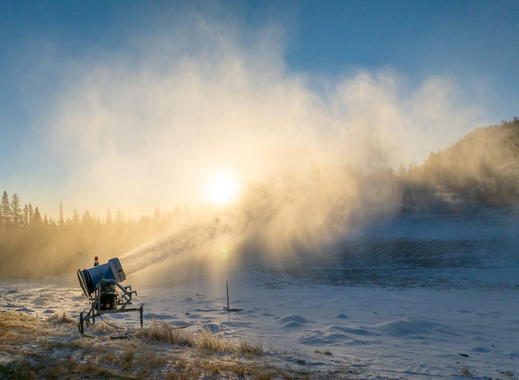 Snowmaking has begun at Mt. Rose in preparation of the 2026-27 season. A snowgun sprays snow onto the frozen ground at sunrise.